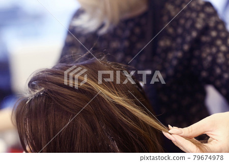 hairdresser hand with hair dye making haircut and hair coloring on client closeup photo hairdresser hand with hair dye making haircut and hair coloring on client closeup photo 79674978