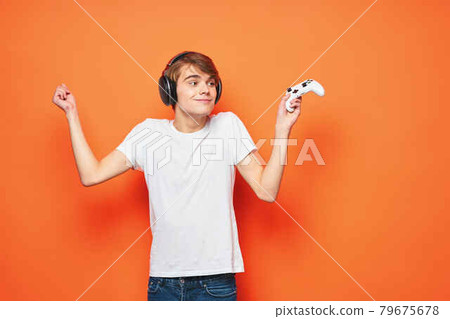 guy in a white t-shirt with a joystick in his hands entertainment games technology 79675678