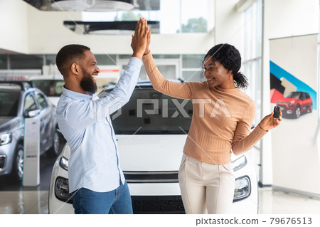 Joyful African American Couple Giving High Five After Buying New Car Joyful African American Couple Giving High Five After Buying New Car 79676513