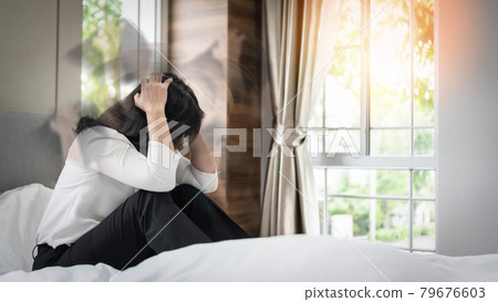 Vertigo illness with dizziness in woman patient on bed in bedroom at home feeling dizzy, faint with spinning movement inside head from benign paroxysmal positional vertigo (BPPV), migraine headaches 79676603