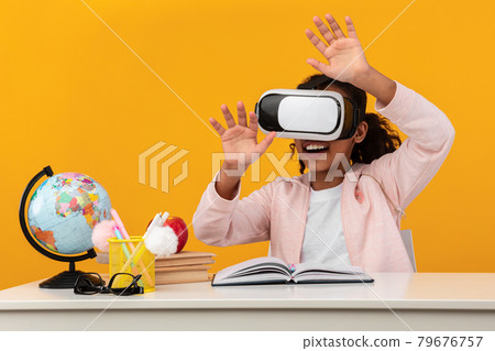 Excited African American Schoolgirl Wearing Virtual Reality Glasses 79676757