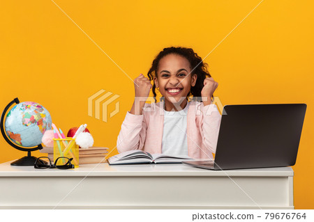 Portrait of emotional black girl cheering with clenched fists 79676764