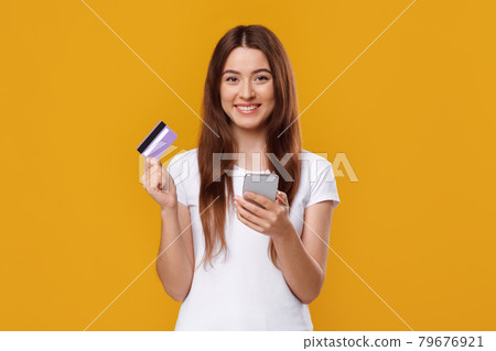 Happy young lady with smartphone and credit card Happy young lady with smartphone and credit card 79676921
