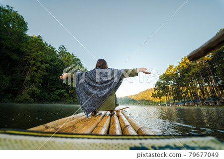 solo asian woman travel by thai local bamboo boat in tropical forest and lake in autumn season solo asian woman travel by thai local bamboo boat in tropical forest and lake in autumn season 79677049