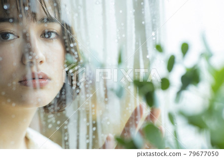 Woman by the window, rain 79677050