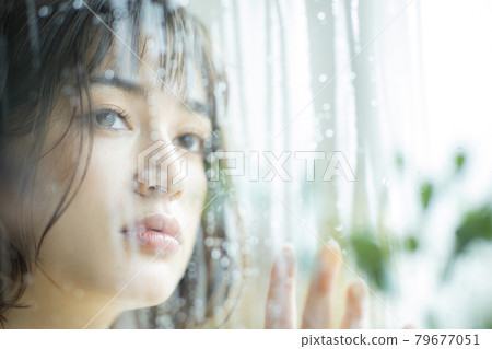 Woman by the window, rain 79677051