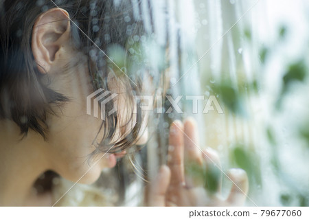 Woman by the window, rain 79677060