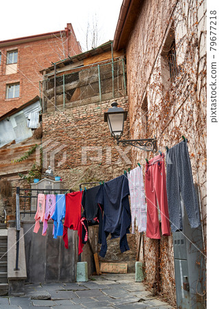 Household traditions in Georgia. The washed laundry is dried on the balcony outside 79677218