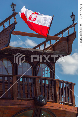 Swinoujscie. Polish flag at the stern of the old ship. Swinoujscie. Polish flag at the stern of the old ship. 79677283