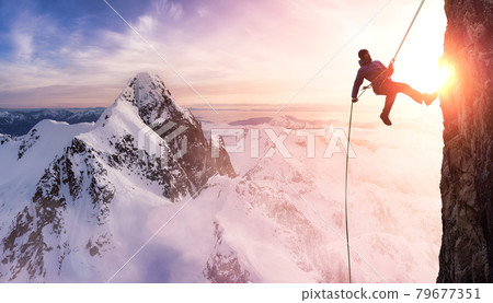 Rock Climbing Man Rappelling from a Cliff 79677351