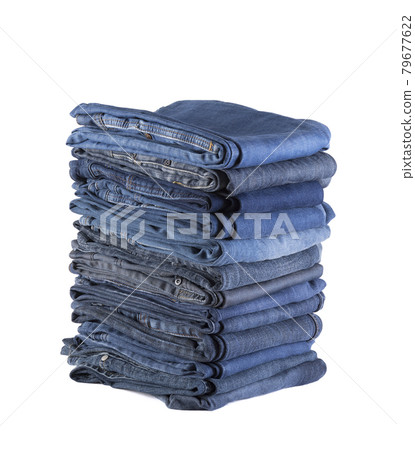 Stack of blue jeans isolated on white background with clipping path Stack of blue jeans isolated on white background with clipping path 79677622