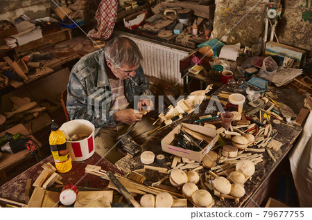 Wooden handmade sailboat in carpentry workshop. Wooden handmade sailboat in carpentry workshop. 79677755