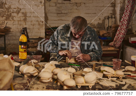 Wood artist, craftsman, carpenter in a workshop for the manufacture of handmade wooden toys. Safe ecological toys for children 79677757