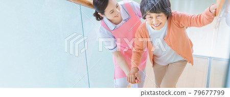 Senior women and care staff on the stairs 79677799