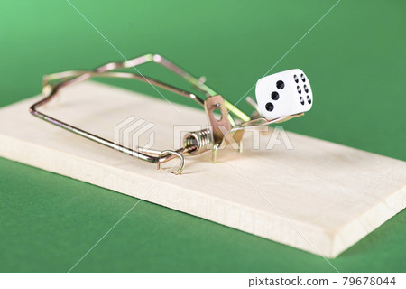 Dice and mousetrap, game trap, on a green background, get into gambling addiction Dice and mousetrap, game trap, on a green background, get into gambling addiction 79678044