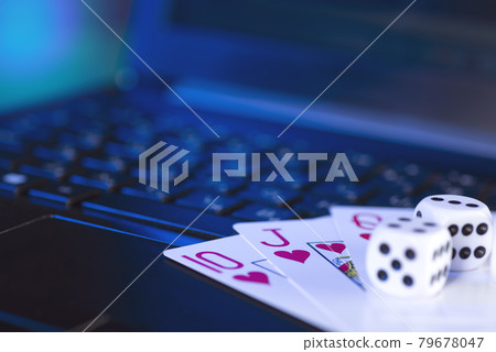 Online gaming platform, casino and gambling business. Cards and dice on laptop keyboard, toned in blue Online gaming platform, casino and gambling business. Cards and dice on laptop keyboard, toned in blue 79678047