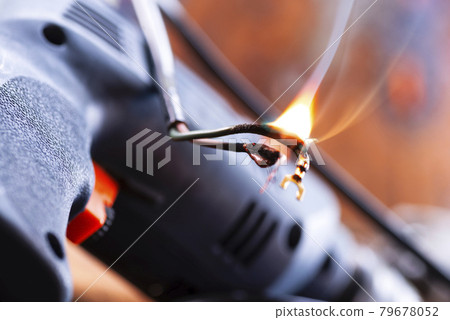 Power tool repair. Details of electrical appliance and repair tools on a wooden table in a repair shop Power tool repair. Details of electrical appliance and repair tools on a wooden table in a repair shop 79678052