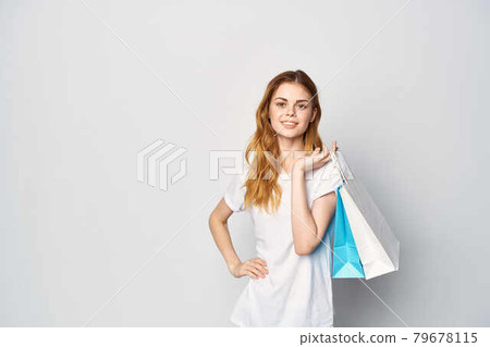 cute red-haired woman in white t-shirt packs shopping lifestyle cute red-haired woman in white t-shirt packs shopping lifestyle 79678115