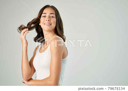 pretty brunette in white t shirt hairstyle grooming isolated background pretty brunette in white t shirt hairstyle grooming isolated background 79678134