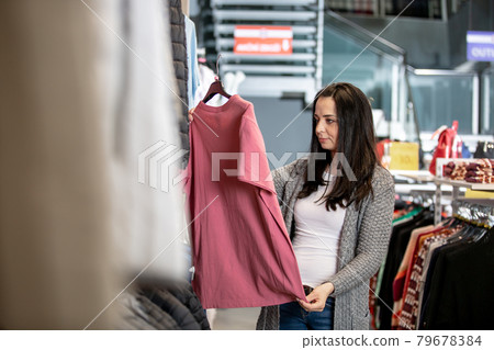 Young woman shopping in the clothes store, shop concept Young woman shopping in the clothes store, shop concept 79678384