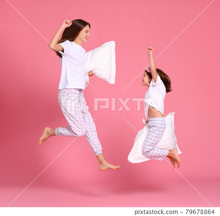 Excited mother and daughter jumping in morning 79678864