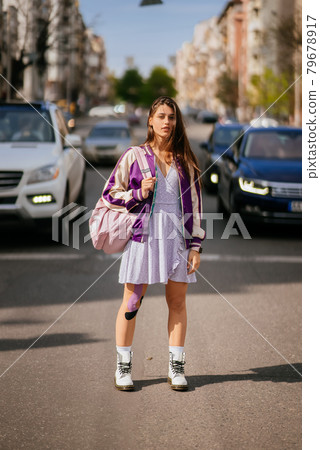 Pretty young woman, walking at the street. 79678917