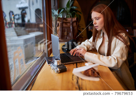Coffee time, confident woman using mobile phone and laptop in cafe, working Coffee time, confident woman using mobile phone and laptop in cafe, working 79679653