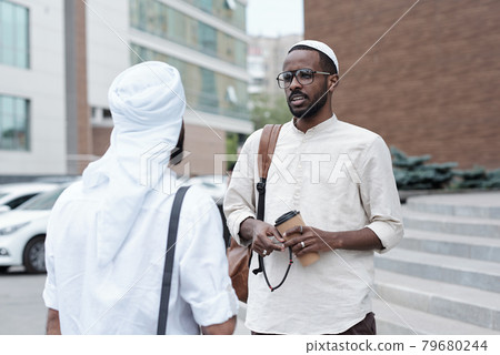 Muslim Man Drinking Coffee With Business Partner Muslim Man Drinking Coffee With Business Partner 79680244