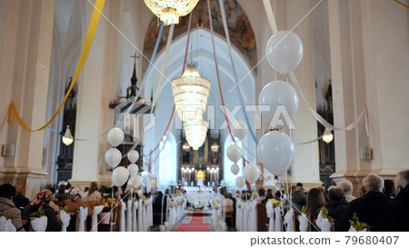 White balls in a Catholic church during a divine service. White balls in a Catholic church during a divine service. 79680407
