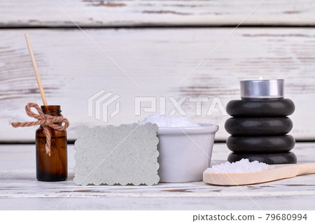 Body oil bottle with stones and spoon for spa treatment. 79680994