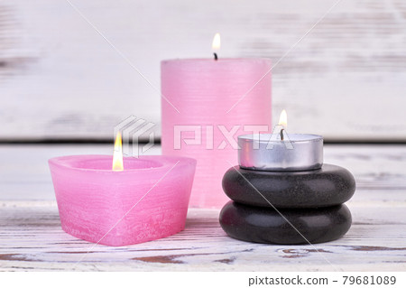 Burning candles and black polished stones for spa. Burning candles and black polished stones for spa. 79681089