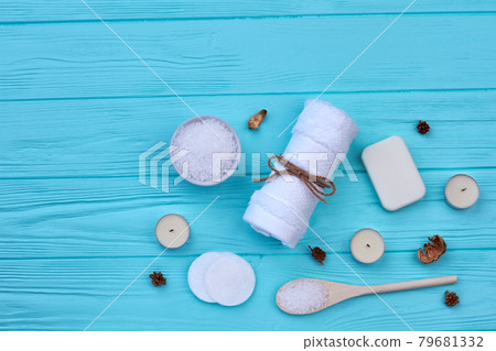 White towel with salt and candles on blue wooden table. 79681332