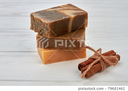 Stack of handmade soap blocks with cinnamon on white desk. Stack of handmade soap blocks with cinnamon on white desk. 79681462