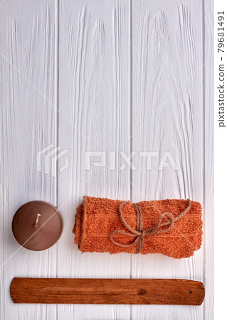 Brown with candle and towel on white wooden desk. Brown with candle and towel on white wooden desk. 79681491