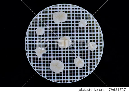 Metal free ceramic crowns of different teeth lying on a ceramic trigger stand. 79681737