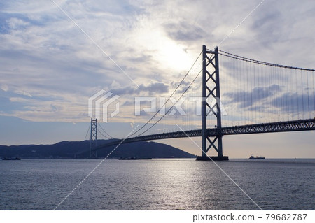 Akashi Strait and Akashi Kaikyo Bridge with the sunlight backlit on a clear day 79682787