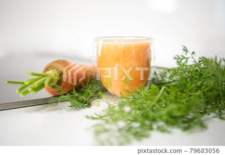 Fresh organic carrot juice in glass isolated on mable countertop. Healthy food 79683056