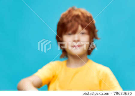 Red-haired boy smile yellow t-shirt studio cropped view Red-haired boy smile yellow t-shirt studio cropped view 79683680