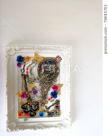 Hand mirror and key in a picture frame Hand mirror and key in a picture frame 79683763