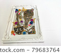 Hand mirror and key in a picture frame 79683764