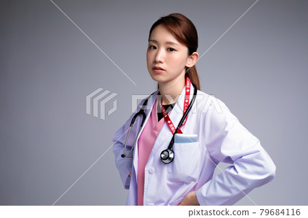 A tired young female doctor 79684116