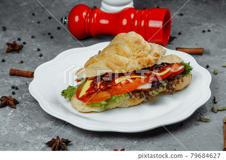 Delicious ham and cheddar cheese croissant with salad Delicious ham and cheddar cheese croissant with salad 79684627