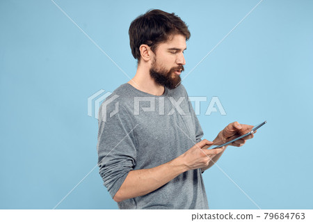 Man with tablet in hands technology lifestyle wireless device blue background 79684763