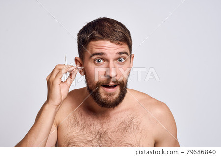 Bearded man with bare shoulders cotton swabs hygiene body care 79686840