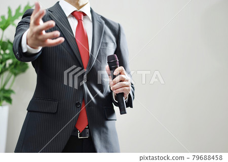 A businessman with a microphone 79688458