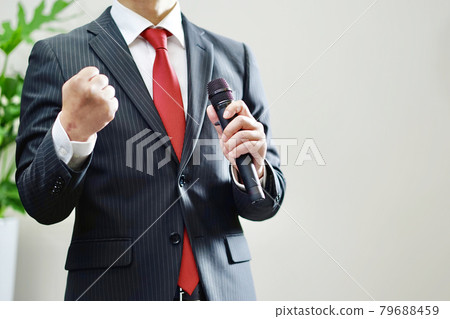 A businessman with a microphone 79688459