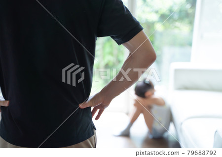 A girl crouching and crying, and adults watching her A girl crouching and crying, and adults watching her 79688792