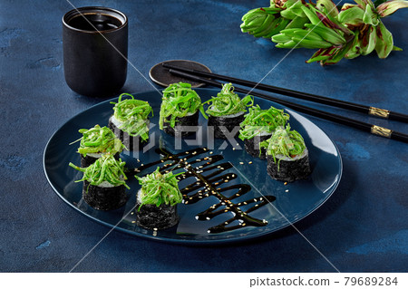 Makizushi rolls with wakame seaweed, asparagus, bell pepper, nut sauce 79689284