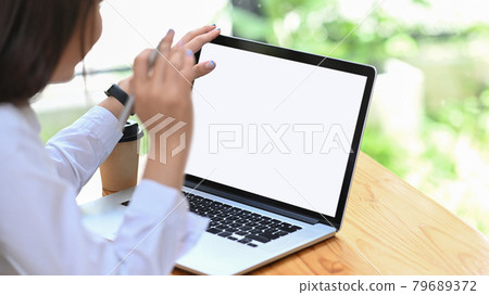 Businesswoman reading information on laptop computer. Businesswoman reading information on laptop computer. 79689372
