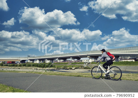 Woman riding a road bike Woman riding a road bike 79690952